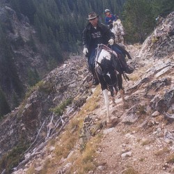 Kaptain carrying Lyle safely on a rocky trail in the Bighorn Mountains